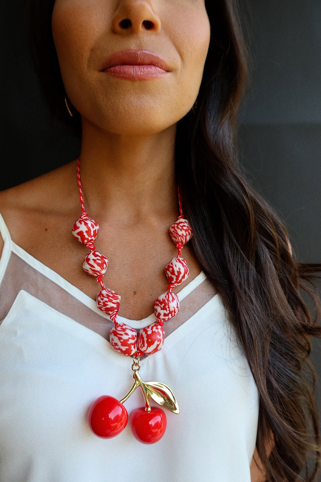 CHERRY BOMB (RED BEADS ON CORD)